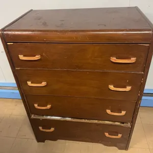 Brown Four-Drawer Wood Dresser With Assorted Craft and Hobby Supplies