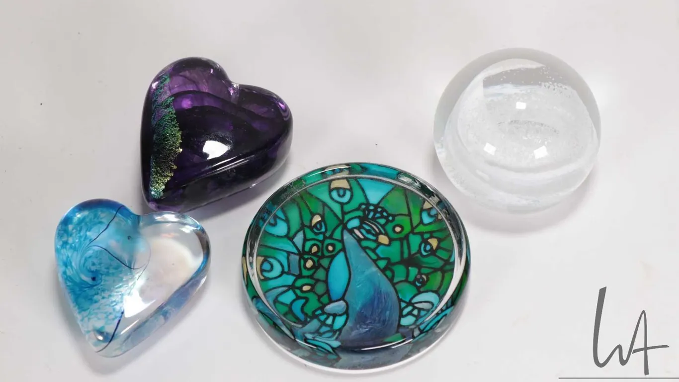 Four hand blown art glass paper weights including Caithness and possible unlabeled Robert Held