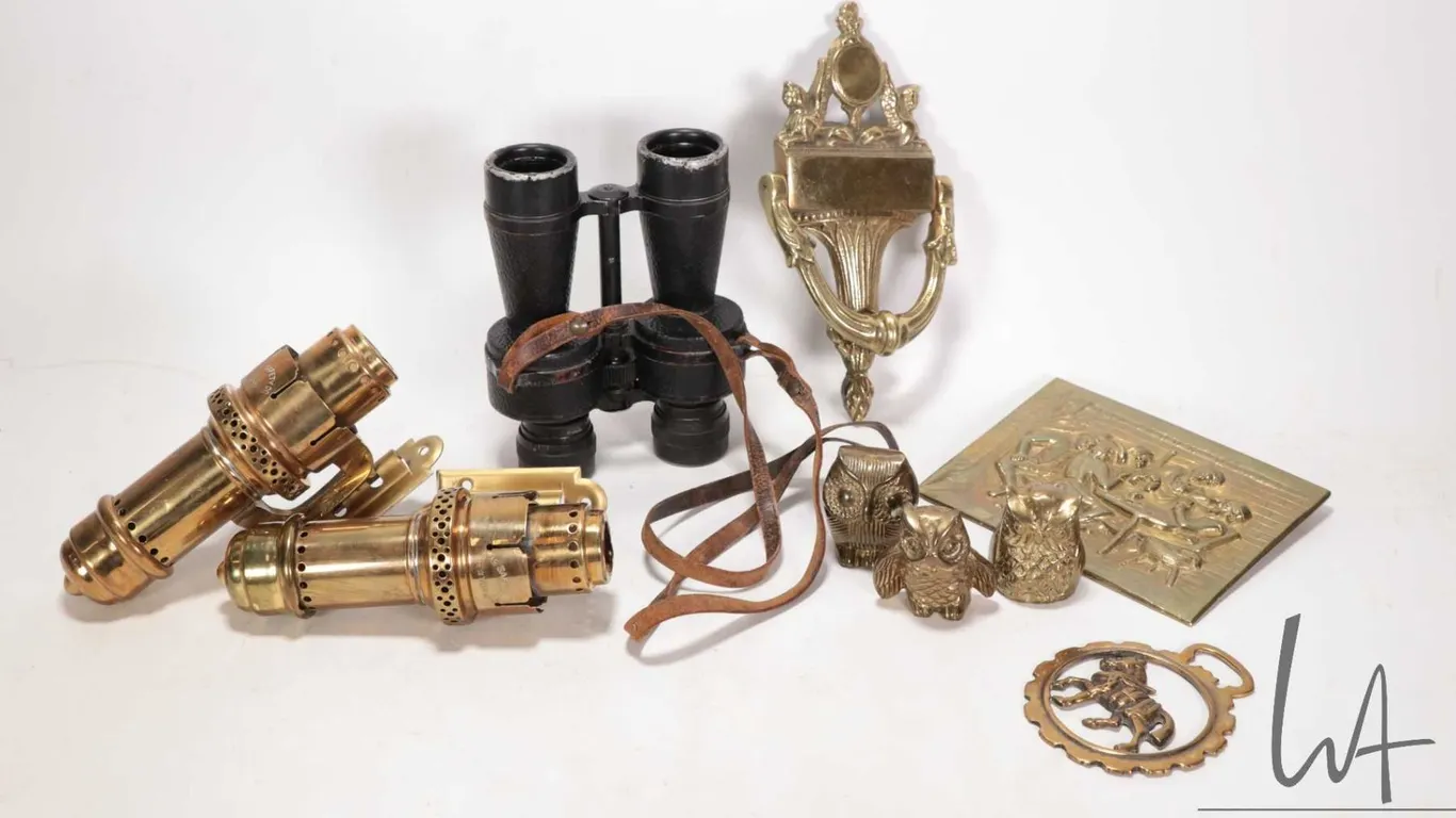 Selection of brass collectibles including a pair of brass wall mount candle sconces, a bas relief ca