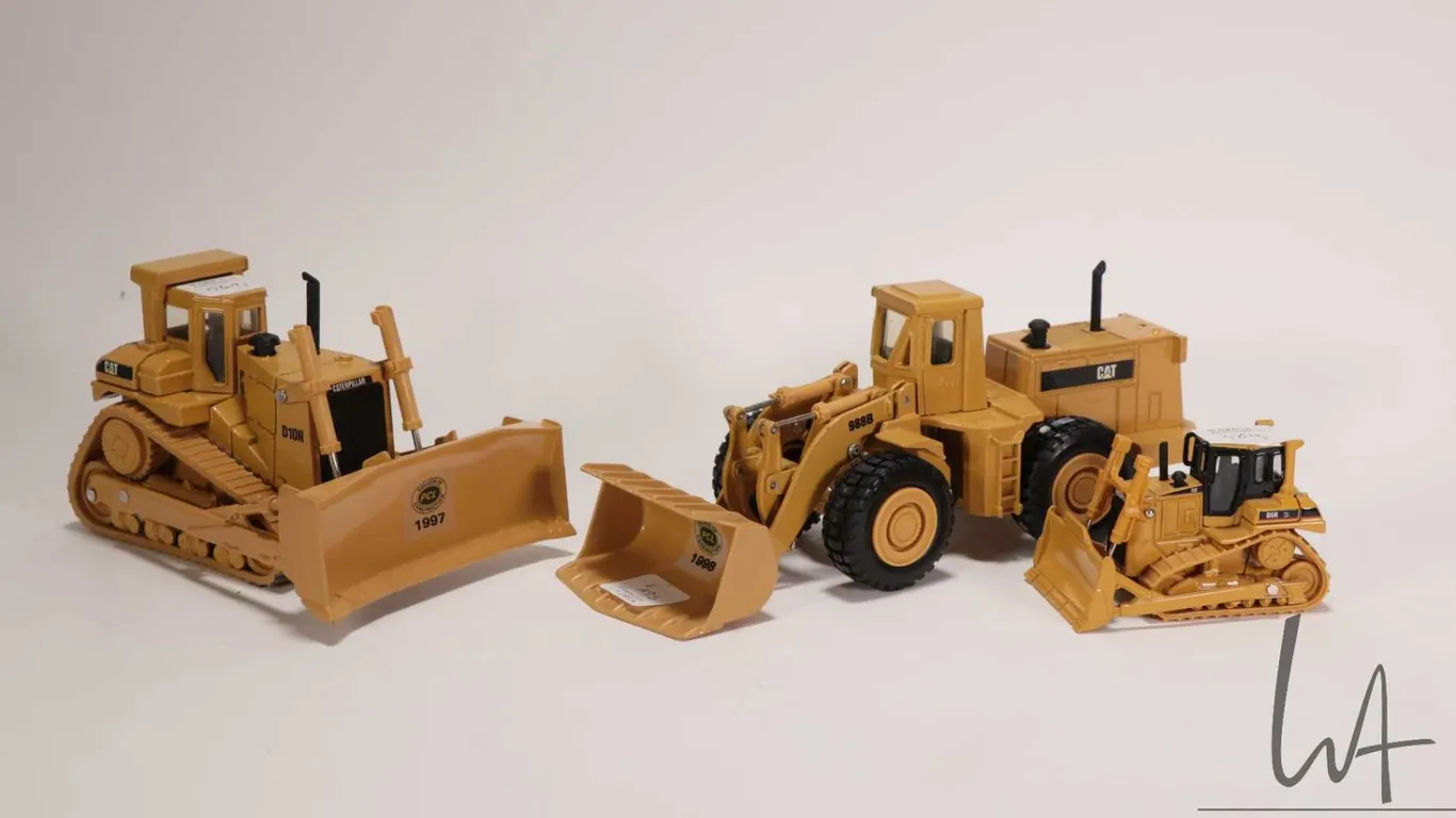 Three Ertl 1:48 scale die cast models including a Caterpiller D-10N, a Caterpillar 988B loader and a