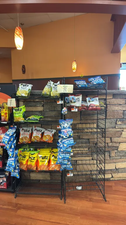 Metal wire display merchandisers. Features black metal wire construction with multi-tier shelving. Includes 57" and 51" racks; one unit is mounted on