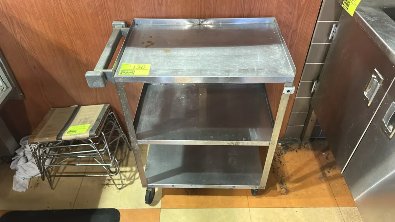 Stainless steel 3-tier utility cart. Features three solid stainless steel shelves with raised lips and an integrated push handle. 24" x 16". Mounted o