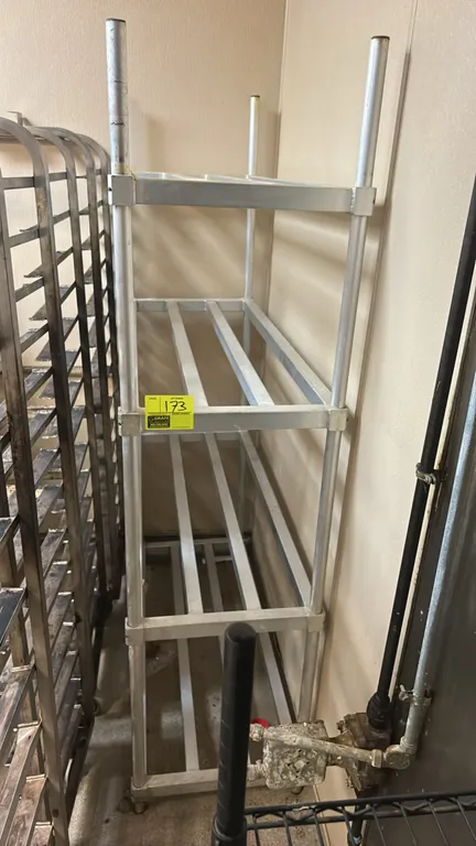 Aluminum 3-tier slatted storage rack. Features welded tubular aluminum construction with three slatted shelf tiers. 47" x 20".