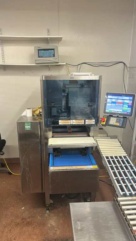 2022 Ishida WM-AI automatic wrapping machine. Features stainless steel construction, color touchscreen wrapper control interface with price computing
