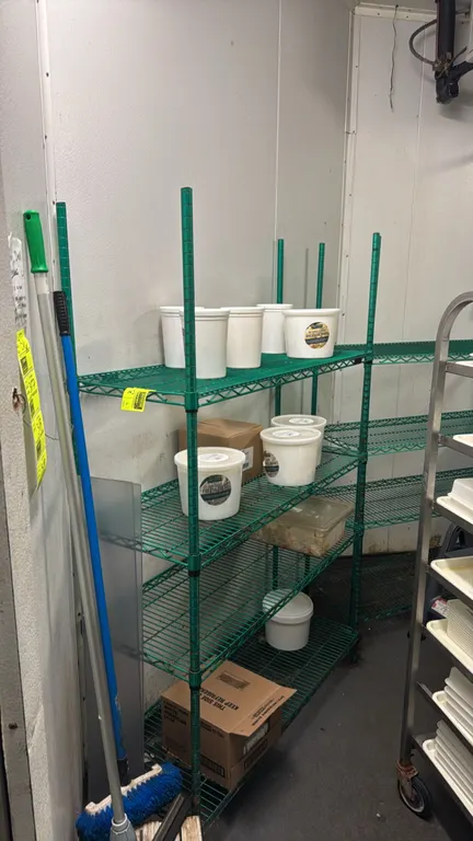 Green metal multi-tier wire shelving racks. Features adjustable wire shelves. Dimensions: (2) 48"L x 18"W x 86"H and (2) 60"L x 18"W x 86"H. Contents
