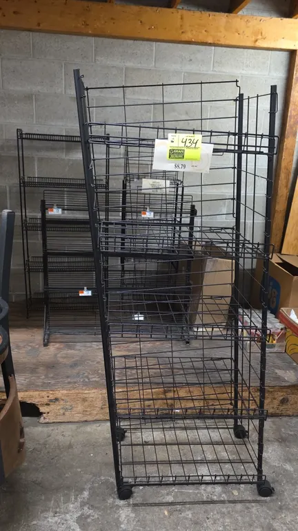 Assorted metal multi-tier merchandisers. Features black wire and steel construction, multi-tier display shelving, integrated price tag channels, and w