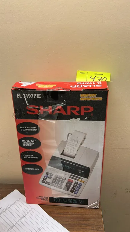 Sharp EL-1197PIII electronic printing calculator. Features a 12-digit blue fluorescent display, two-color ribbon printing, and tax, calendar, and cloc