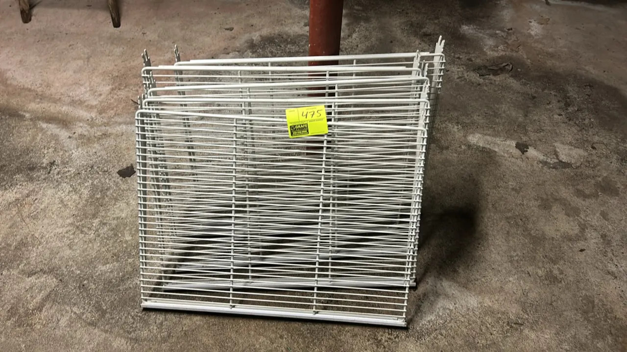 Metal wire display shelves. Features white-coated wire construction with integrated mounting brackets and front channel molding.