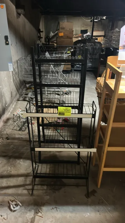 Metal wire multi-tier display racks. Features black metal frames with wire shelves, including (1) 3-tier rack with label channels and (1) 5-tier rack.