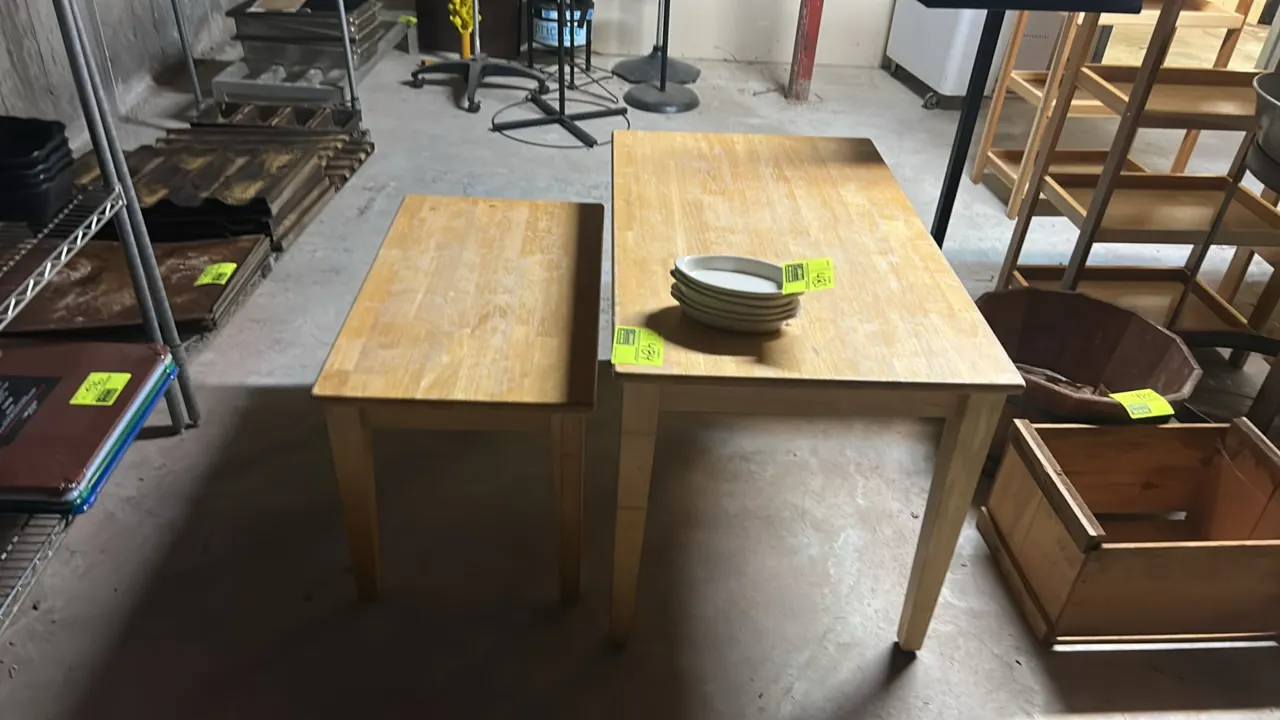Wooden nesting tables. Features solid wood construction with a light natural finish and tapered square legs. Dimensions: 39" x 24" and 31" x 18". Cont