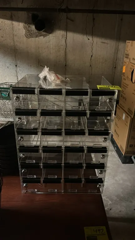 Poly 24-compartment lockable organizer cabinet. Features clear construction, 24 individual locking compartments with cam locks, and label holders. Inc
