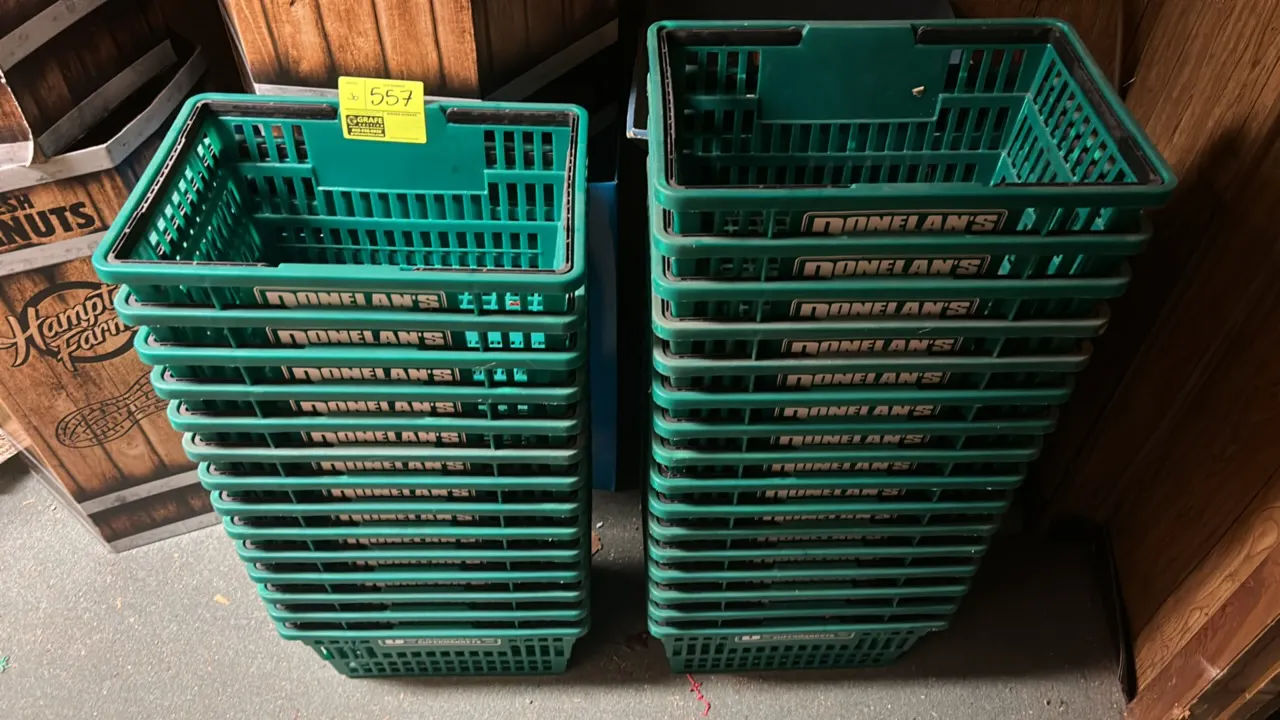 Poly shopping baskets. Features green molded plastic construction with vented sides, dual black folding handles, and Donelan's branding. Stackable des