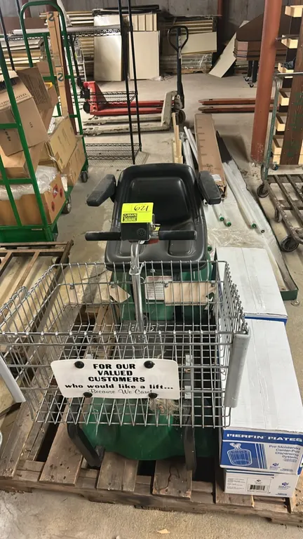 Mart Cart motorized shopping cart. Features a front wire basket, molded seat with armrests, handlebar controls with key switch, and onboard charging c