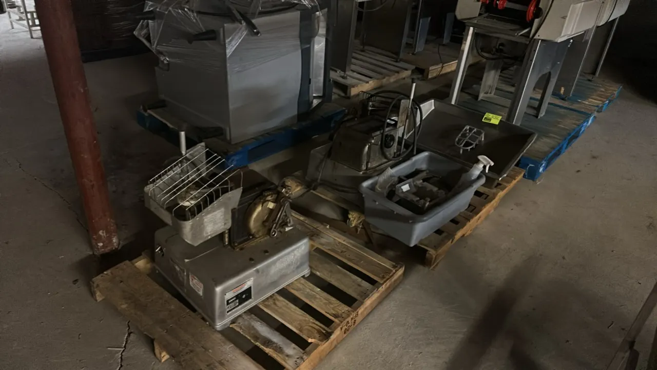 Hollymatic Super Model 54 food portioning machines. Includes (2) portioning machines, (1) stainless steel feed hopper tray, and a tote of assorted par