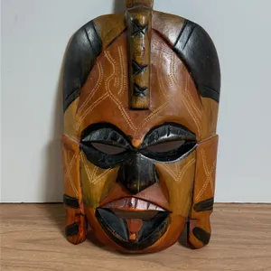 Carved Wooden Mask with Geometric and Textured Detailing