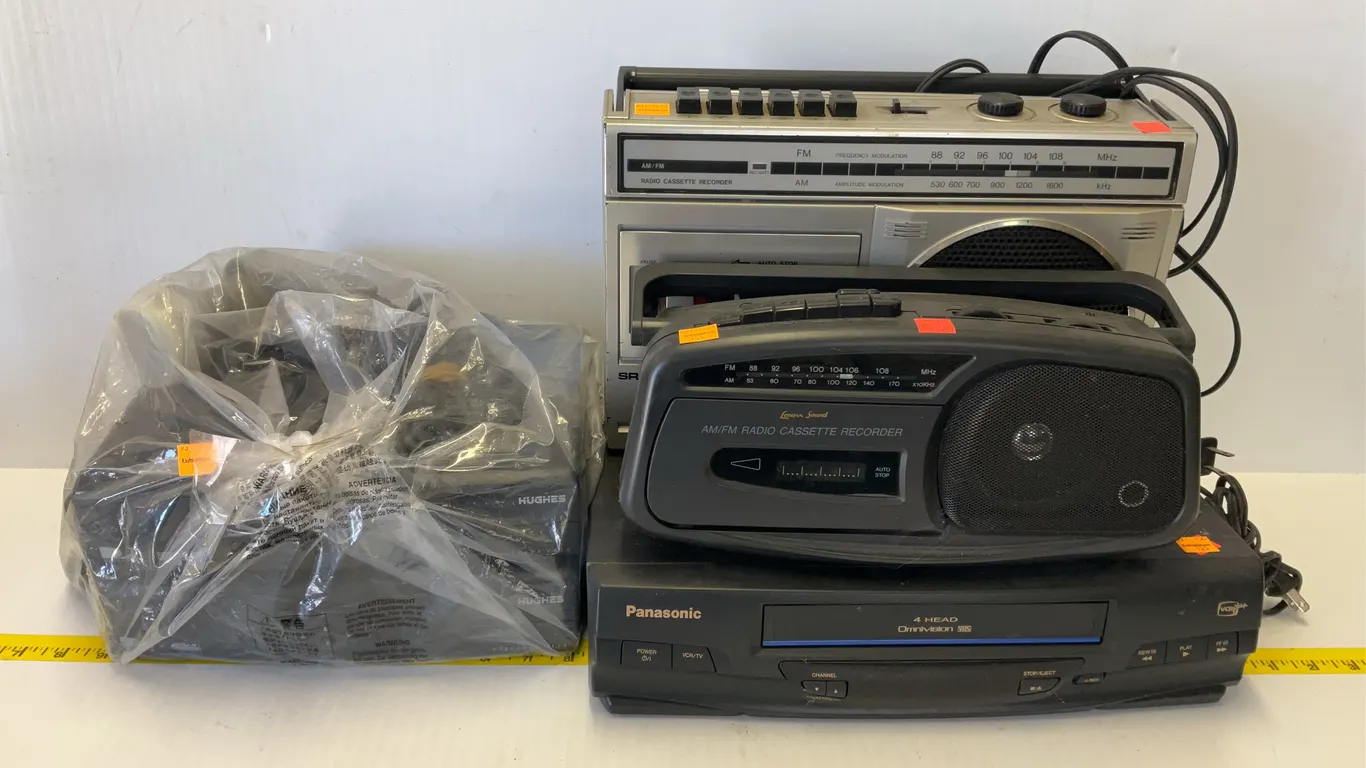 Panasonic VCR, (2) Hughes Net Boxes, (2) Cassette Radios