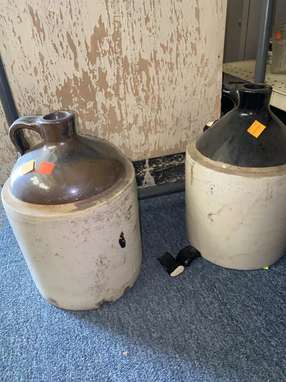 (2) Stone Crock Jugs (HANDLE IS BROKEN ON ONE)