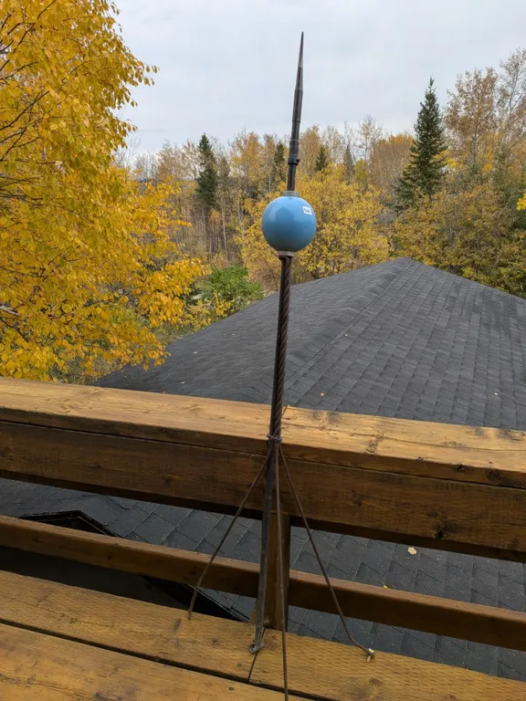 Vintage lightning rod with Dodd & Struthers tip and blue glass globe, mounted on a metal tripod. Abo