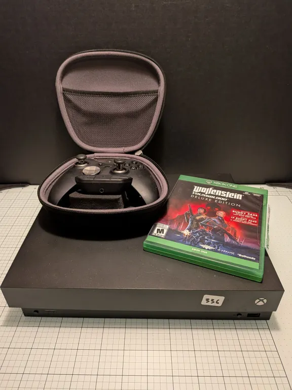 Xbox One X 1 TB console. Working great, but comes with no cords (just what's in picture). Also, old
