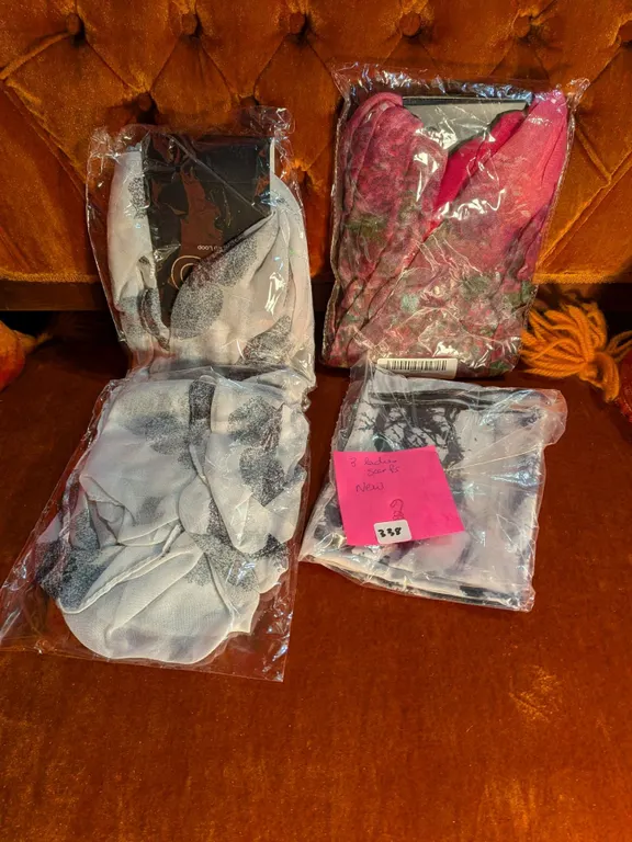 Three new and unused ladies scarves, assorted patterns.