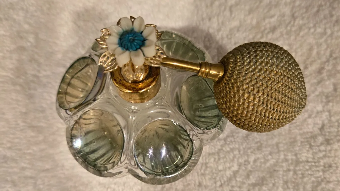 Vintage clear and greenish-tinted pressed glass perfume atomizer bottle. Gold tone spray pump with