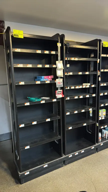 Laminate multi-tier merchandisers. Features black laminate construction, adjustable shelving with price tag molding, and side panels. 24" x 74" each.