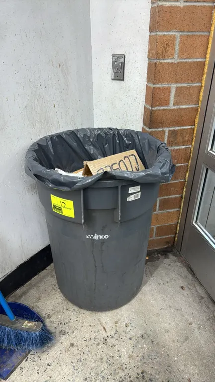 Winco polyethylene trash can. Features round molded design with integrated side handles. Gray finish. Contents and broom not included.