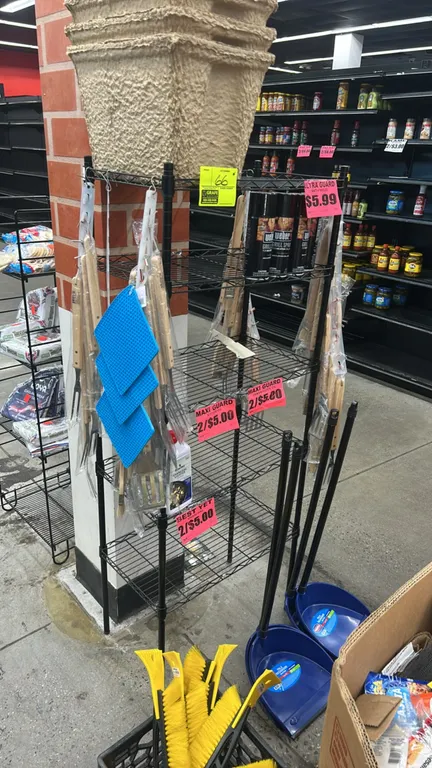 Metal wire multi-tier display rack. Features black wire construction with 5 shelves. Contents not included.