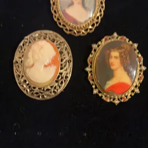 Three cameo type brooches