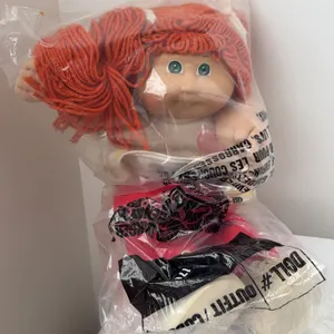 Vintage Cabbage Patch Kids girl doll sealed inside a clear plastic manufacturer bag