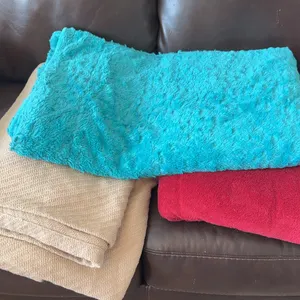 Three folded soft household blankets