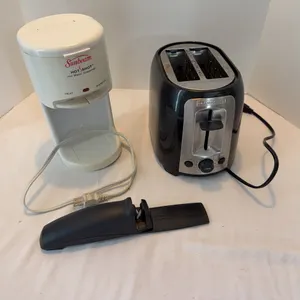 Kitchen counter items. Pampered chef, knife, sharpener, coffee, pot, and toaster.