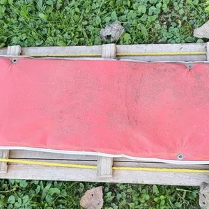 Vintage 7 ft. wooden slat toboggan complete with a curved front roll and a red padded cushion