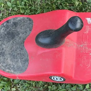 Zipfy Freestyle Mini Luge Snow Sled in red with a black control handle and anti-skid seat pad.