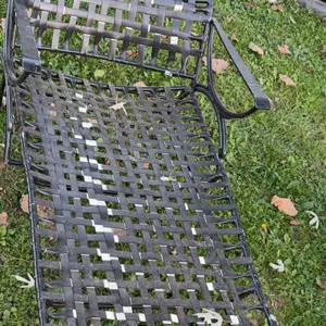 Metal frame chaise lounge with a basket weave vinyl strap/lacing design