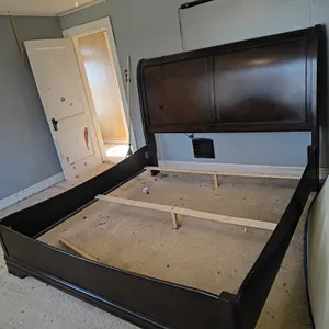 Dark Wood Sleigh Bed Frame With A High Scrolled Headboard