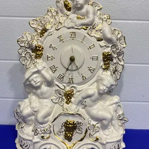 Porcelain Clock with Cherubs and Gilded Accents, Decorative Design