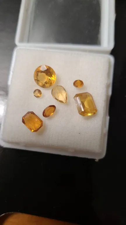 Six Mixed-Cut Yellow Gemstones in Case
