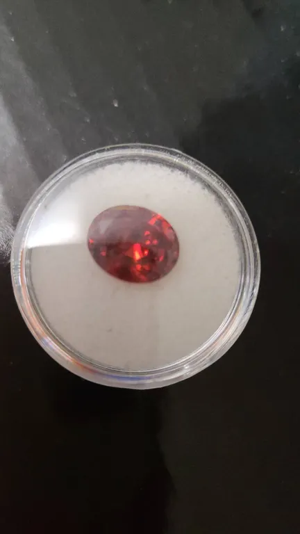 Faceted Oval Red Gemstone in Display Case, Loose Stone