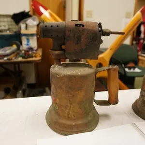 antique blowtorch with wooden handle