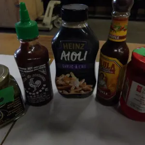 SHELF PULLS (AS IS):  FLAT C/W 10 ASSORTED BOTTLES OF SAUCES (AS PICTURED)