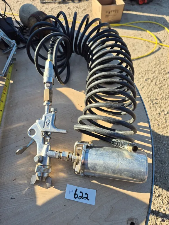 Touch up spray gun with hose.