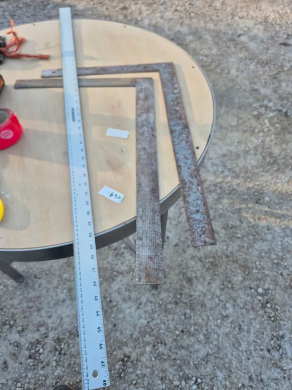 Two carpenter, squares and the metal ruler.