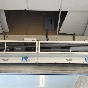 Mars Air Door overhead air curtains. Features front intake grilles and white metal housing. 4'L each. Overhead mount.