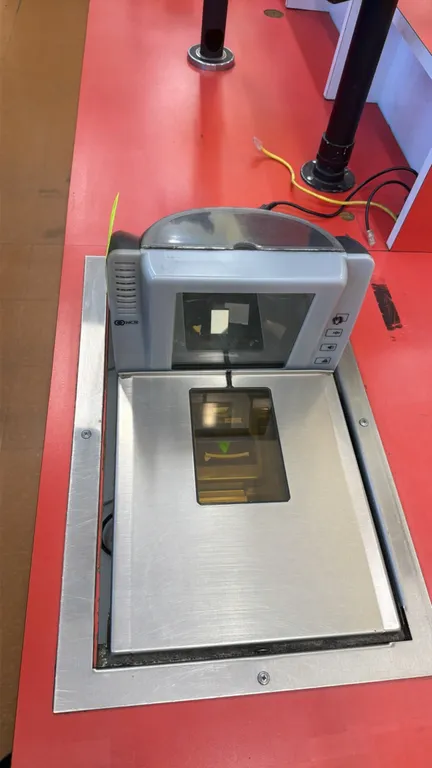 NCR 7878-2000 point-of-sale grocery scanners. Features integrated bi-optic scanning windows, stainless steel scale platters, and push-button controls.