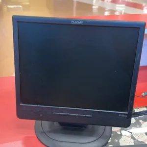 Assorted computer monitors, including Planar PL1500M and Dell models. Features desktop stands and mounting hardware. Keyboard and checkout counters no