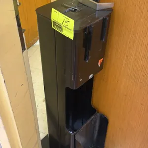 Purell metal sanitation station. Features black finish, dispenser mounting bracket, and integrated lower waste or storage compartment. Freestanding ba