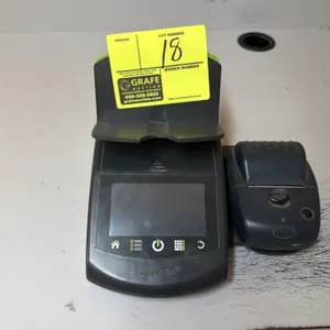 Volumatic money counting scale. Features digital display, button controls, bill and coin tray, and attached receipt printer.