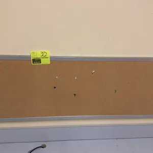 Wall-mounted corkboard and wall shelving. Includes 4' x 1' corkboard with aluminum frame and adjustable wall shelving system with (2) slotted standard