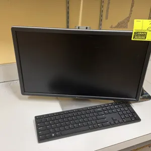 Dell computer monitor. Includes keyboard, mouse, and mouse pad. Mounted on an adjustable desktop stand.